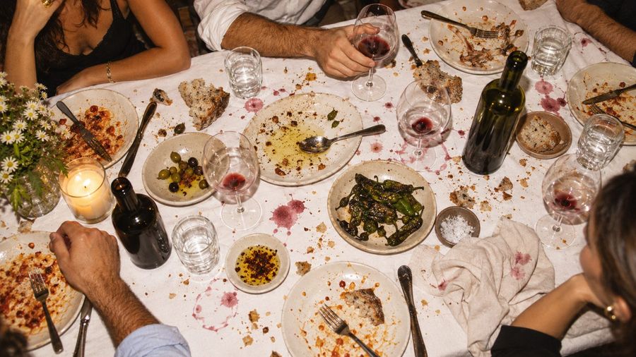 The table after dinner, wine stains and empty plates